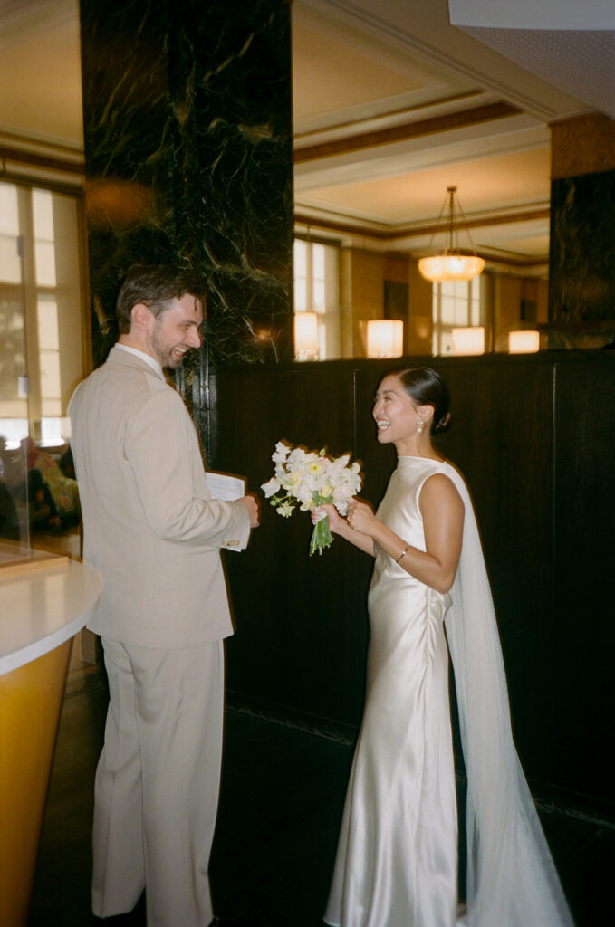 Celebrating with marriage license at Manhattan Courthouse.