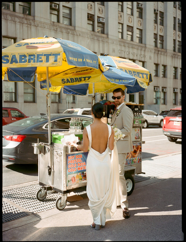 NYC wedding photos at a hot dog stand in Manhattan.
