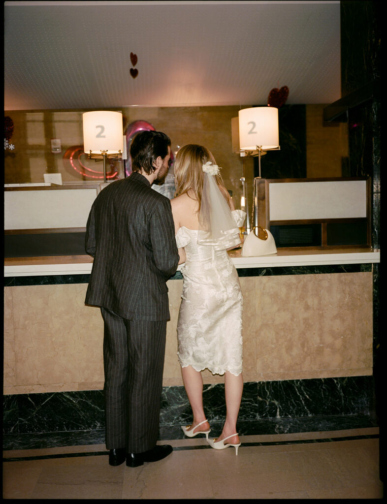A couple signing their marriage certificate at the Manhattan Courthouse.