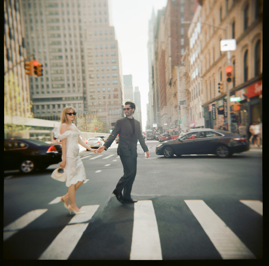 Fresh of eloping, newlyweds walk through the streets of downtown Manhattan.