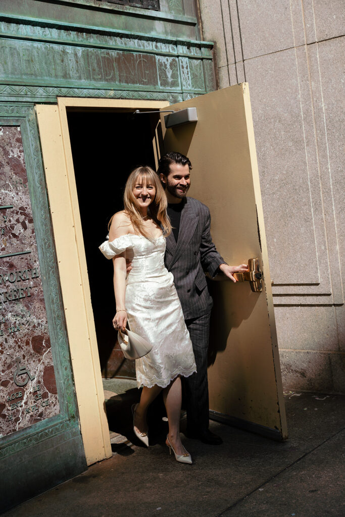 The newlyweds exiting the courthouse doors after their elopement.