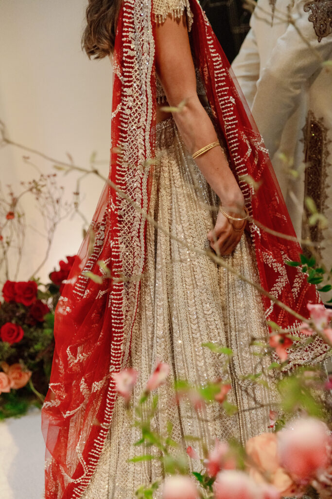Indian bridal portriats. Her lehenga catches the light with each step.