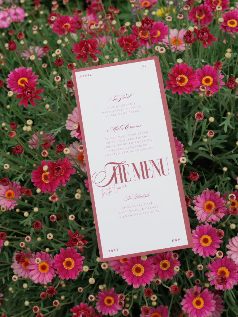 The menu and floral decor for an Indian American wedding rehearsal dinner.