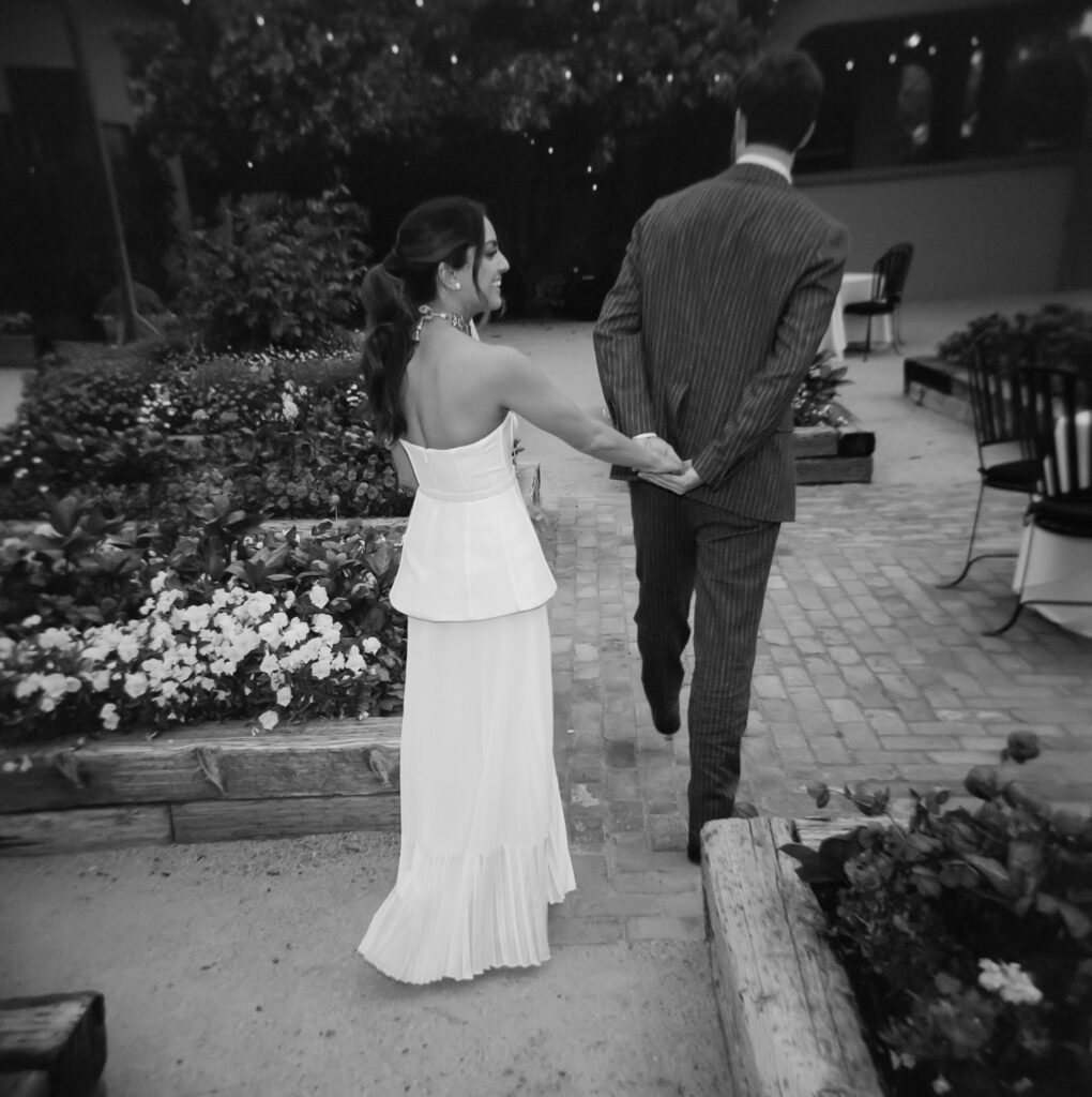 Paul leads Kismet as they enter their wedding welcome party.