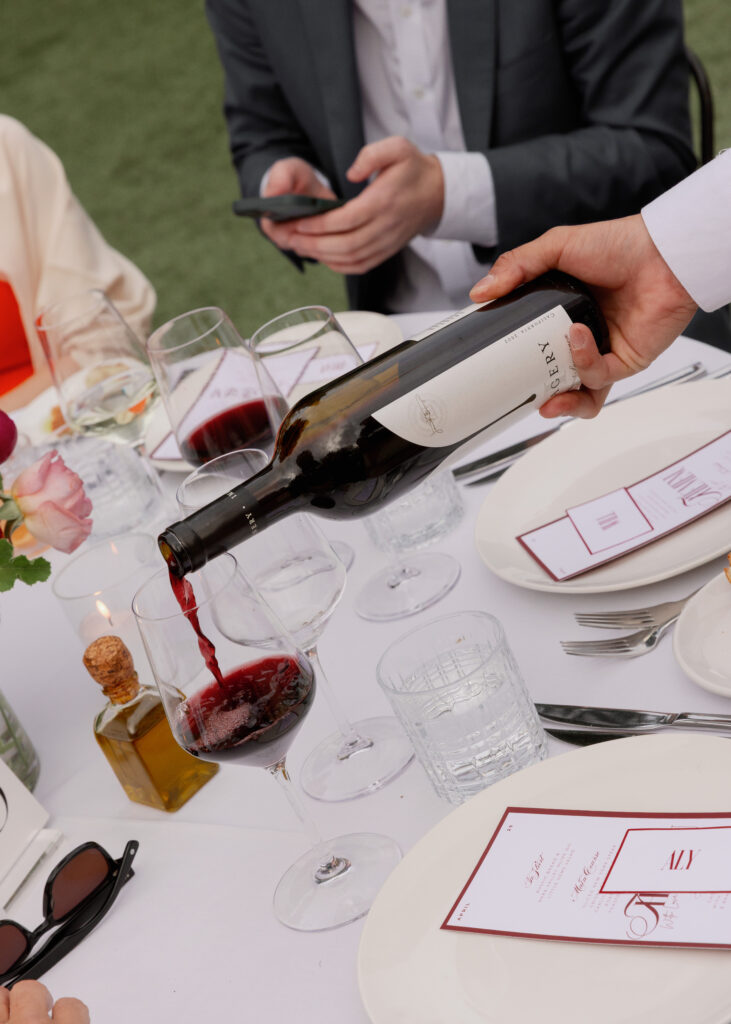 Guests at an Indian wedding poured glass of wine in Napa Valley.