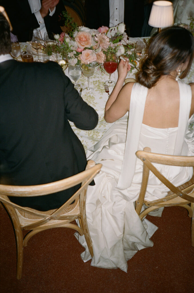 The bride and groom enjoy moments together during their wedding reception with friends and family. 
