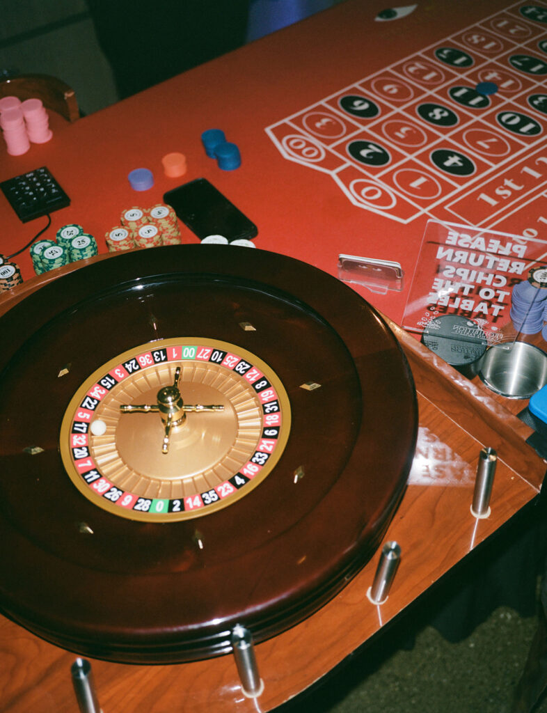 Guests enjoy casino inspired wedding reception vibes. 