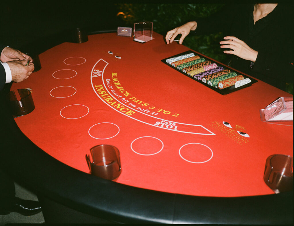 Guests enjoy casino inspired wedding reception vibes. 
