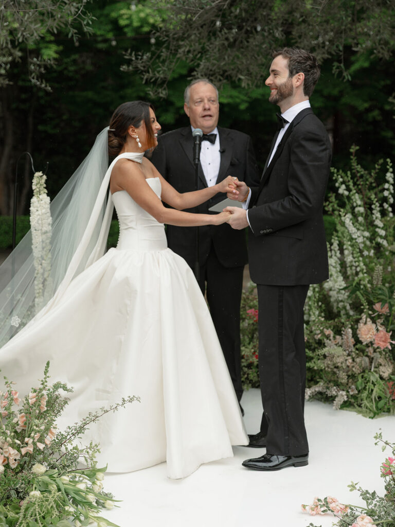Kismet and Paul share a candid moment of joy during their wedding ceremony. 